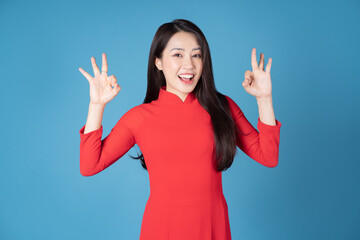 Photo of young Vietnamese woman wearing red ao dai