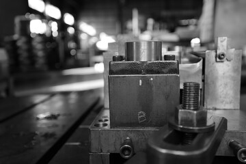 Sheet Metal Stamping Tool Die for Automotive Precision Parts on The Numerical Control Milling Machine Table. Tandem Stamping System. At a High Quality Technology Factory. Black and White Photography.