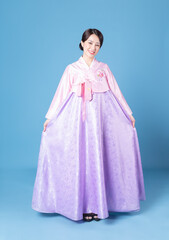 Obraz na płótnie Canvas Image of young Korean woman wearing hanbok on background