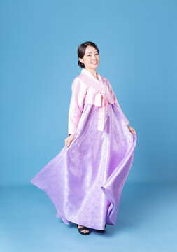 Image of young Korean woman wearing hanbok on background