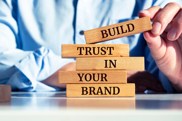 Wooden blocks with words 'Build trust in your brand'. Business concept