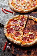 Fresh baked homemade peopperoni pizzas with chili peppers.