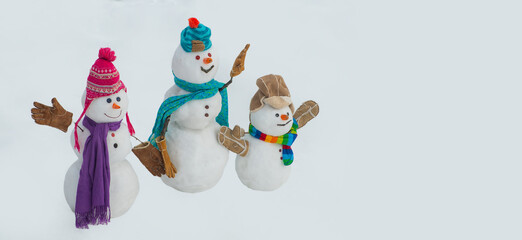 Christmas and happy new year greeting card with snowman. Funny snowman family in stylish hat and scarf.
