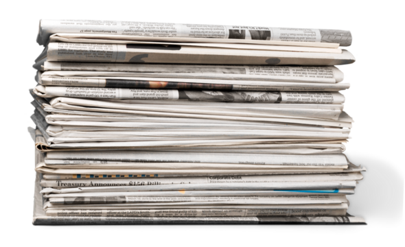 Pile of printed newspapers on white background