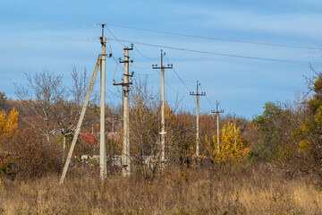 Power lines in the countryside. Poles and wires Ukraine. Autumn sunny day