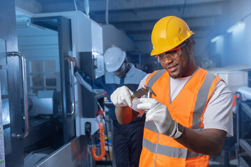 CNC machinery industry car factory, Team african american engineer in uniform checking quality detail