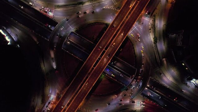 Expressway top view, Road traffic an important infrastructure, car traffic transportation above intersection road in city night, aerial view cityscape of advanced innovation, financial technology	