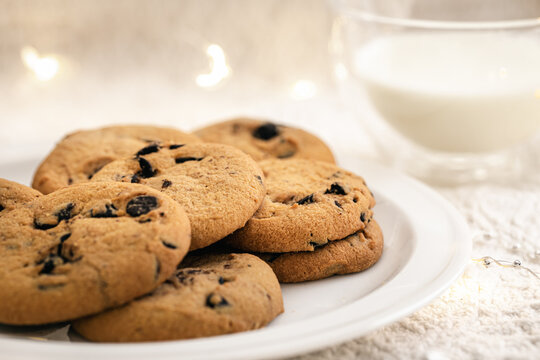 Cookies with chocolate chips close-up and glass of milk.