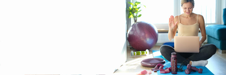 Woman fitness trainer blogger communicates by video call