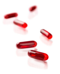 Red medical pills isolated on white background