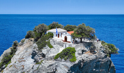 Closeup view of the little church of Agios Ioannis, high up on a steep cliff over the Aegean Sea and famous from the movie Mamma Mia at Skopelos island, Greece