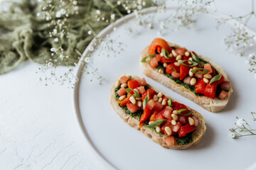 Bruschetta with pesto, tomatoes and nuts