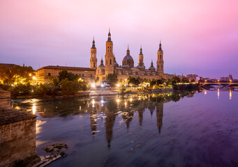 Scenic landscape with the Basilica of El Pilar in Zaragoza at sunrise reflected in the Ebro river