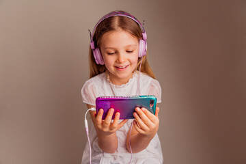 Portrait of smiling girl watching movie with smartphone and headphones