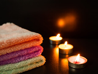 Obraz na płótnie Canvas Towel with Light Candle on Black Wooden Table Background,Aromatherapy Spa Set,Treatment Herb Nature for Beauty Salon,Medicine Hygiene Luxury in Holiday Relax and Good Health.Poster for Bathroom Hotel.
