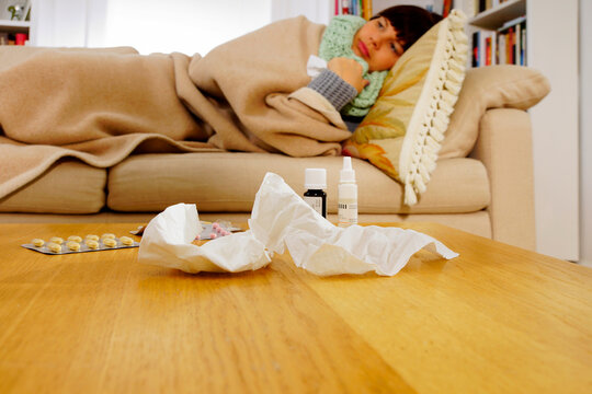 Sick woman lying on sofa