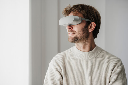 Businessman watching through VR goggles at workplace