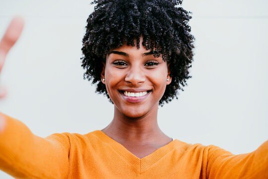 Smiling Woman With Afro Hair Taking Selfie