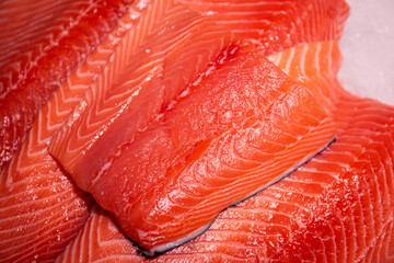 Raw salmon, trout close-up on the showcase of a seafood store.