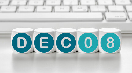 Letter dice in front of a keyboard - December 08