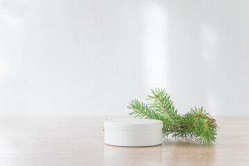 Abstract white empty podium with fir twig and shadow; Mock up stand for product presentation; Christmas holiday background;