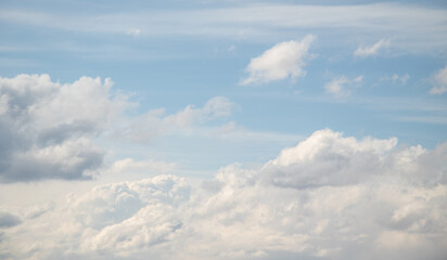 White cumulus clouds against the blue sky.