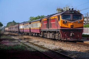 Fototapeta premium Passenger train by diesel locomotive at the railway station.