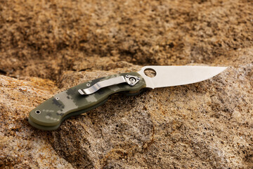 Obraz premium folder knife on the stones