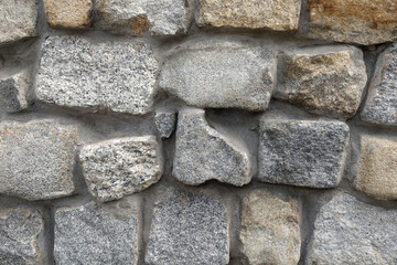 The background of stones in the wall, the texture of the stone.