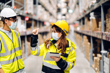 Asian two engineer team shipping order detail on tablet check goods and supplies on shelves with goods background inventory in factory warehouse.logistic industry and business export