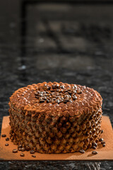 delicious bright cake with fruit on top and filling, the cake is standing on a black table