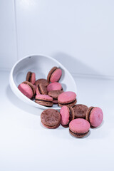 raspberry chocolate macarons, pink brown white dish, french dessert