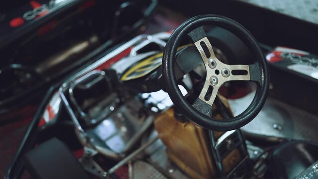 Close-up of the steering wheel of a go-kart without a driver