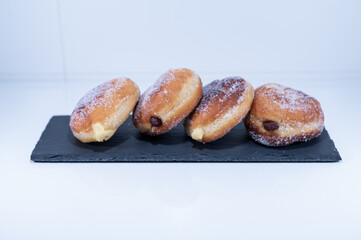 doughnut Berliners cream chocolate handmade black plate