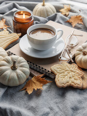 White pumpkins, coffee and autumn leaves