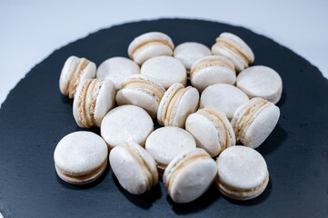 White vanilla macarons, black dish, french dessert