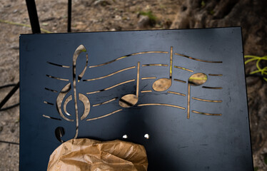 Metal sheet music holder in the shape of a pentagram, with treble clef and musical notes. Lunch...