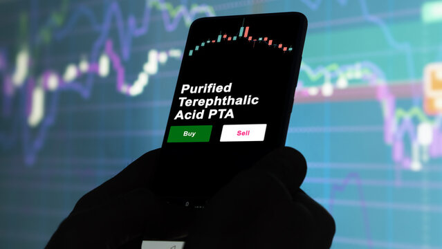 An investor's analyzing the Purified Terephthalic Acid PTA etf fund on screen. A phone shows the ETF's prices purified terephthalic acid pta to invest