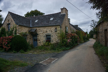 Fototapeta na wymiar Village of Kernevez, traditional stone houses with street, Botmeur, Brittany, France