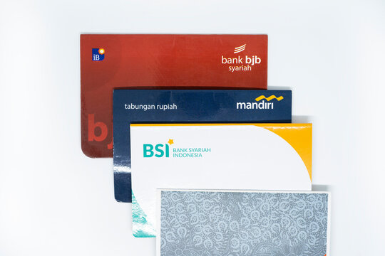 BANDUNG, INDONESIA - OCTOBER 27 2022. BJB Syariah Savings Book, Mandiri saving book, BSI saving book and BNI saving book isolated in white background