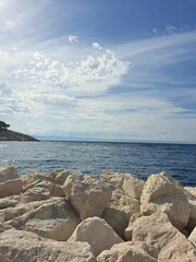 White rocky coast with a blue sea under the sky during daytime, Adriatic Sea in Croatia