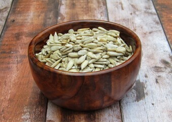 Peeled Sunflower Seeds in a wooden bowl 