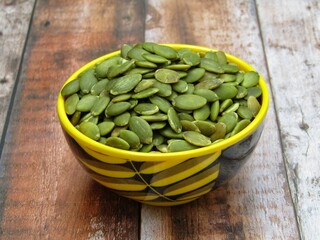 Green pumpkin seeds in a bowl 