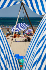 Traditional beach tent and beach umbrella in Dinard Bretagne France