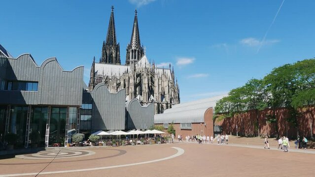 Heinrich Boll Platz and Ludwig museum in Cologne Germany with view of Dom cathedral, slow motion