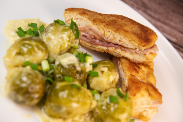 Recipe for homemade chicken fillet cordon bleu style with Brussels sprouts. High quality photo