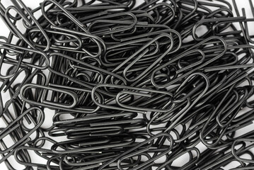 the black paper clips isolated on the white background