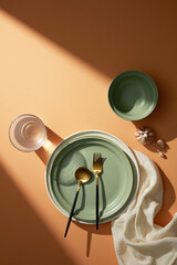 A table is full of ceramic dishes, eating utensils, and glass cups. Tableware collection. 
