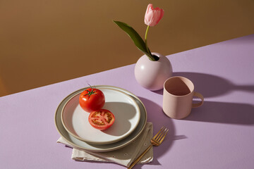Minimalist tableware on the colored background vase of tulip flowers, and ceramic cup decoration.
