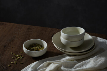  Ceramic tableware setting on the wood table. Modern crockery set for design catalog, magazine or website. Space for text